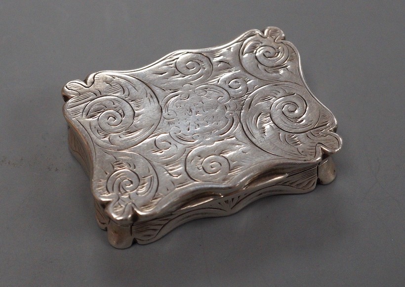 A Victorian engraved silver shaped rectangular snuff box, Edward Smith, London, 1855, 37mm (bale hole? on one side).